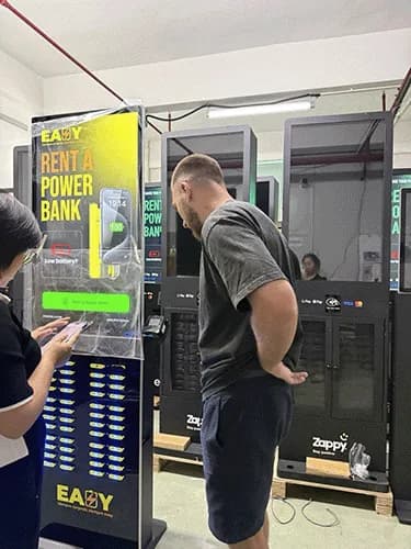 George Reilly at a powerbank manufacturer in China, inspecting a branded rental station